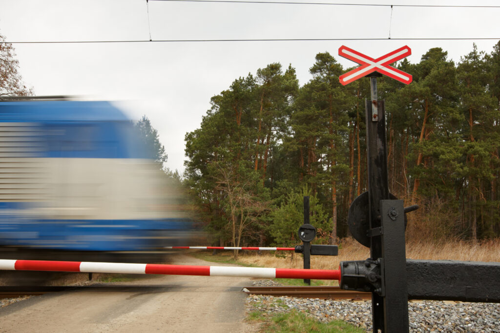 Modern train on obsolete railroad crossing - selective focus - blurred motion
