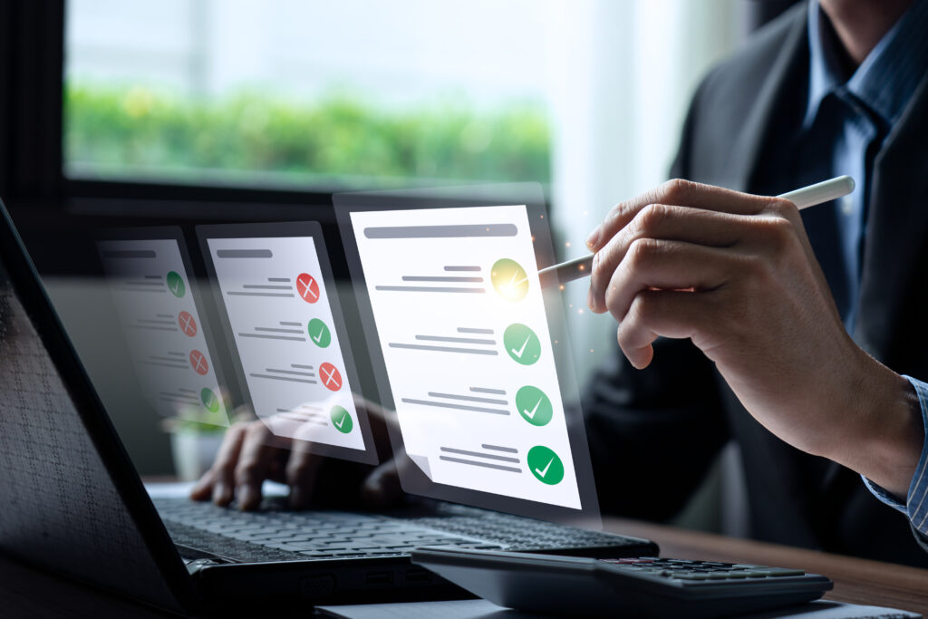 Business performance checklist, businessman using laptop doing online checklist and evaluation.